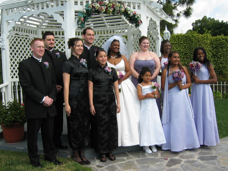 The wedding party poses for pictures outside!