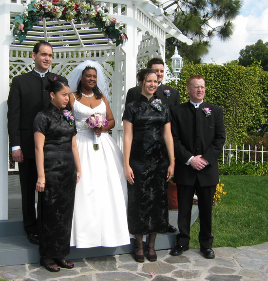 The wedding party poses for pictures outside!